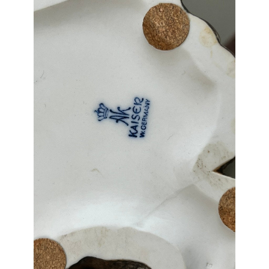 Close-up of the underside of a Rare Kaiser Porcelain American Bald Eagle Sculpture (Limited Edition No. 12/200, W. Germany) by Kaiser, showing the blue crown mark, "KAISER," "W. GERMANY," and nearby circular cork pads.