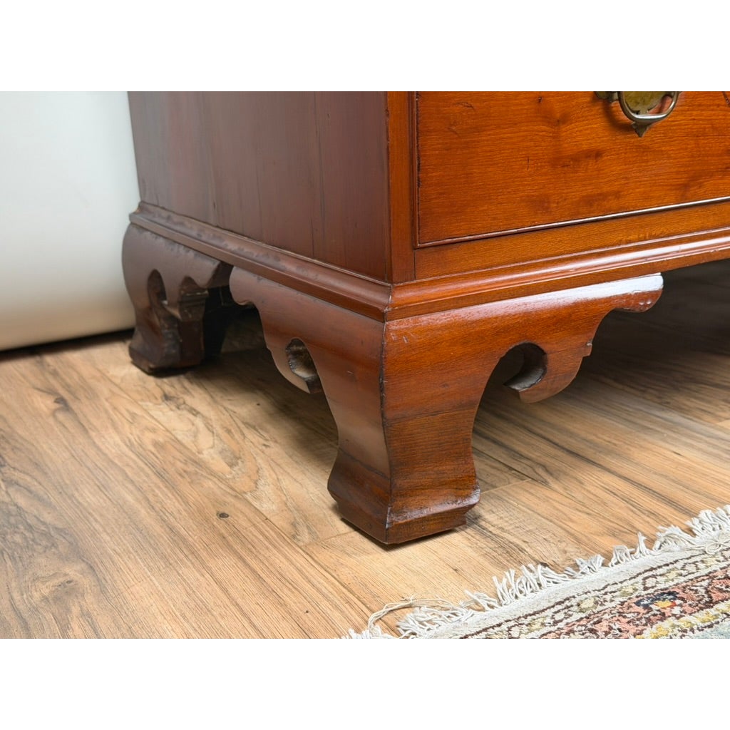 Close-up of a Chippendale Cherry Slant-Front Desk with Ogee Bracket Feet, showing its carved ogee bracket feet.