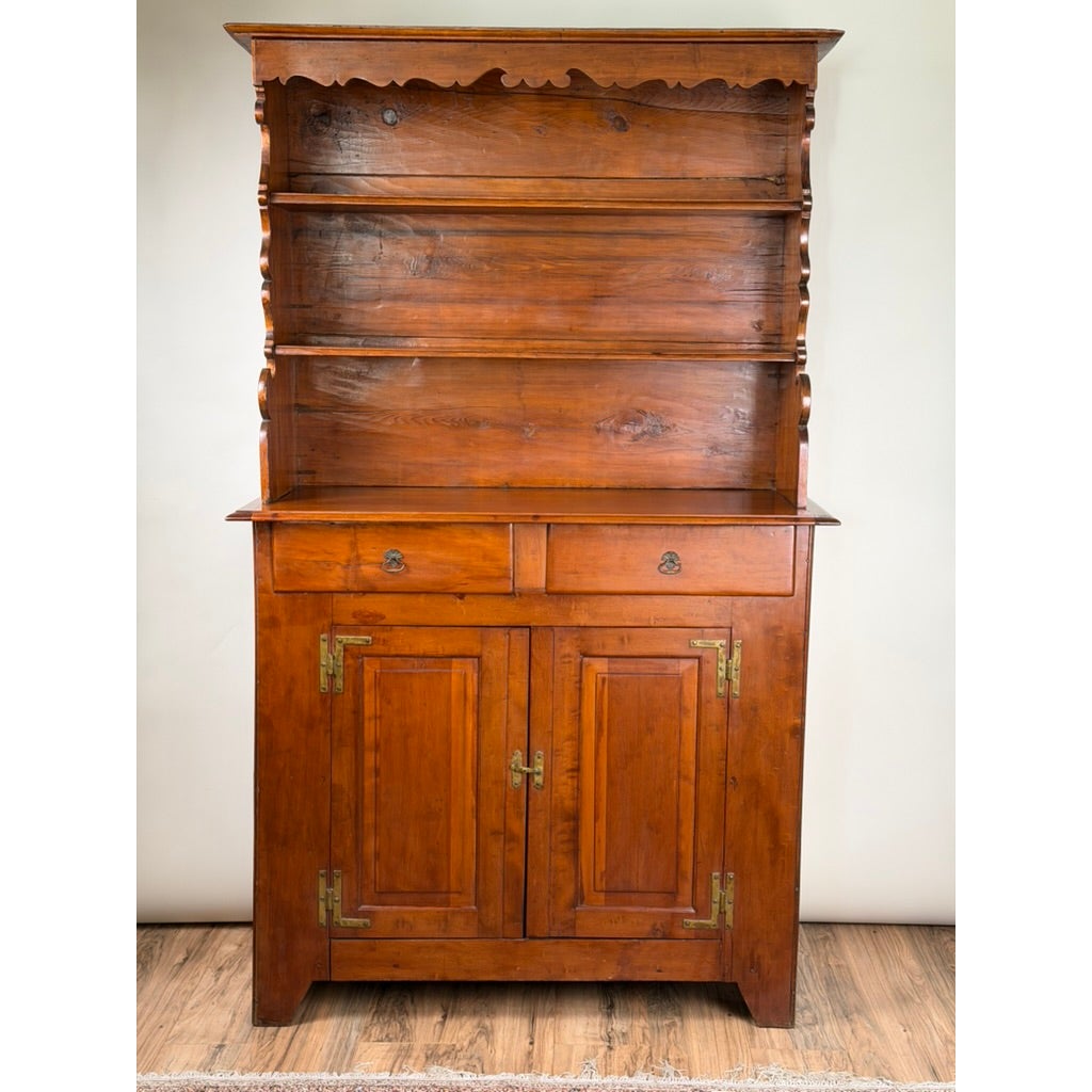 Pennsylvania or Mid-Atlantic Cherry Open Pewter Cupboard, circa 1800–1830, a tall early American cupboard featuring an open top with two shelves, two drawers above, and two lower cabinet doors with metal hinges.