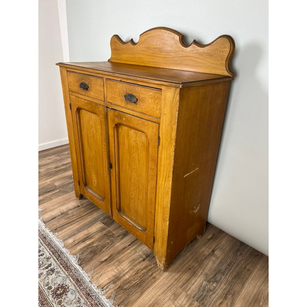 The Antique Victorian Grain Painted Country Jelly Cupboard c. 1870 features two drawers, two doors, and a decorative back panel—ideal for country kitchen storage by a patterned rug and white wall. Brand: None/Unknown.