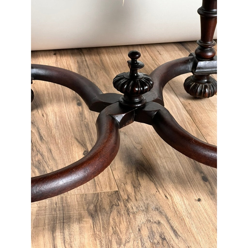 Close-up of the base of an Antique Fine Carved Flemish Side Chair attributed to Daniel Marot, c. Late 17th Century, featuring ornate Baroque-style carving, crossed legs, and a decorative central finial on a light wood floor.