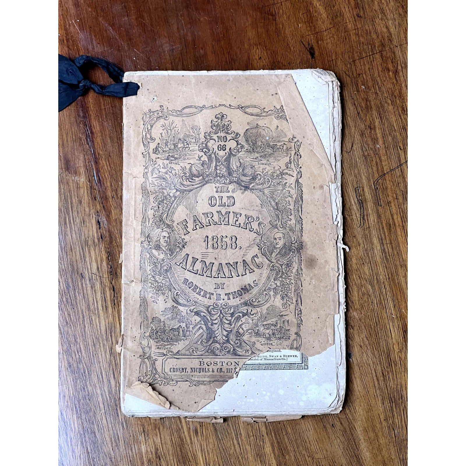 A set of four antique Old Farmer’s Almanacs—1858, 1861, 1864 & 1865 editions by Robert B. Thomas—shows timeworn covers and tattered edges, highlighting the enduring charm of early American print. Brand is unknown.