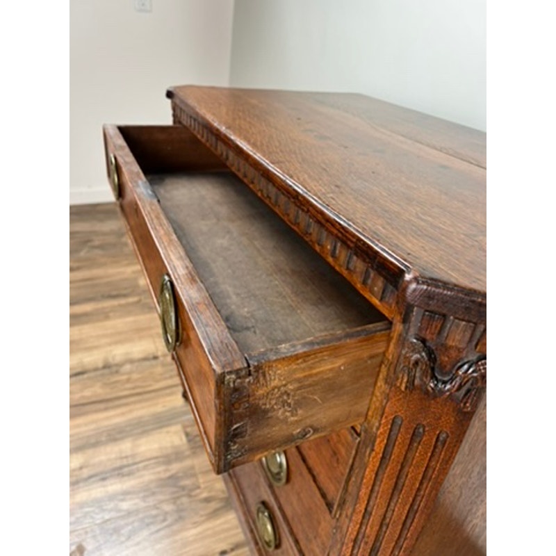 Detail of oak drawers with Louis XVI styling on late 18th century bachelors chest