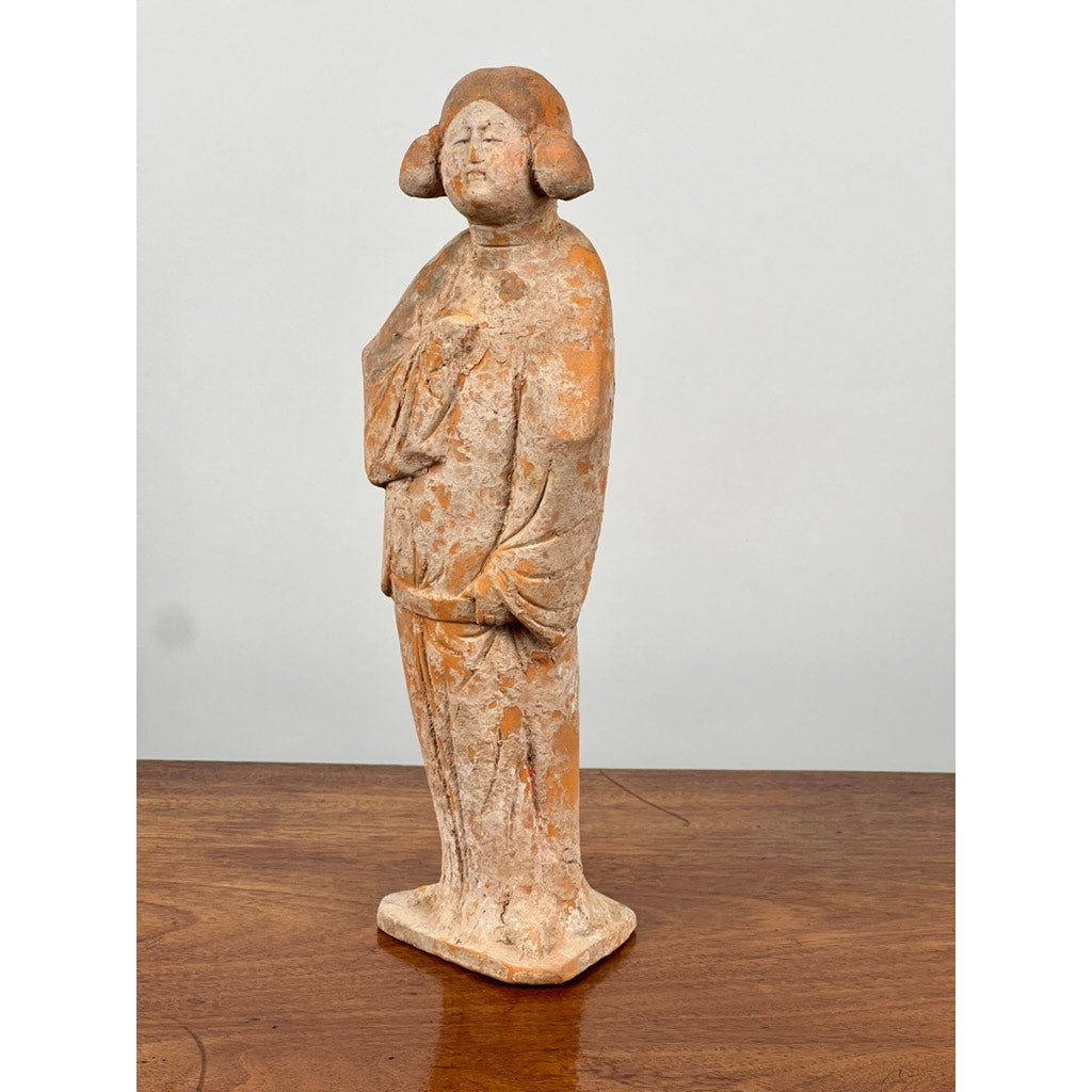An Antique Chinese Tang Dynasty (618-907 AD) terracotta figure of a standing court lady with COA, featuring traditional hairstyle and robe, is displayed on a wooden surface against a plain light background.