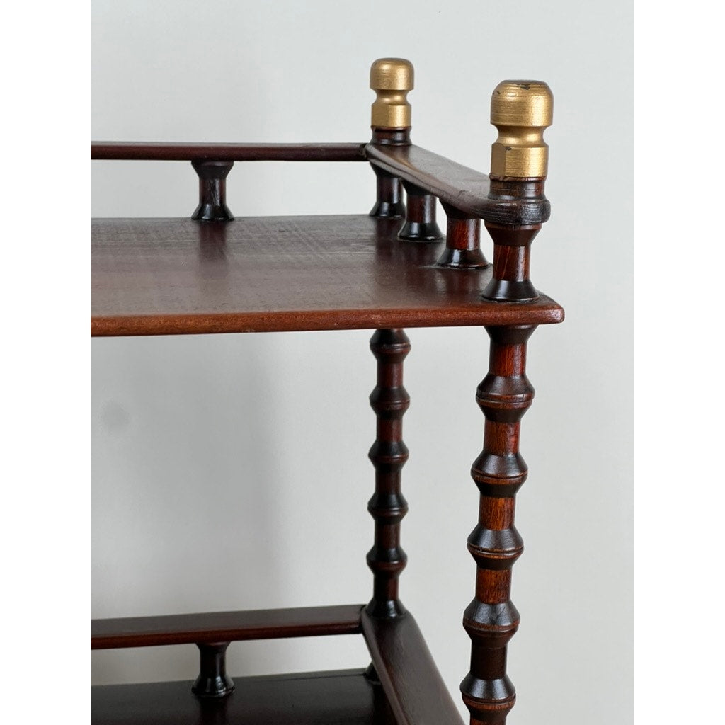 A close-up of a Vintage Bobbin-turned, Three Shelf Wooden étagère or Whatnot, featuring turned legs and elegant dark wood craftsmanship, set against a plain light background. Brand: None/Unknown.