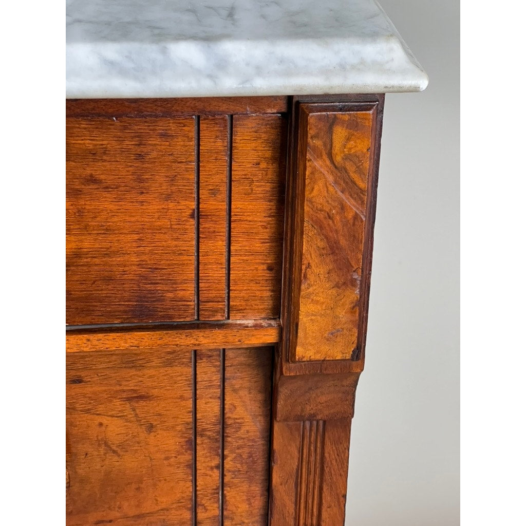 Close-up of an Antique Victorian Marble Top Four Drawer Chest c. 1910, showcasing rich brown tones, visible grain, carved vertical and horizontal lines, and a pristine white marble surface. Brand: None/Unknown.