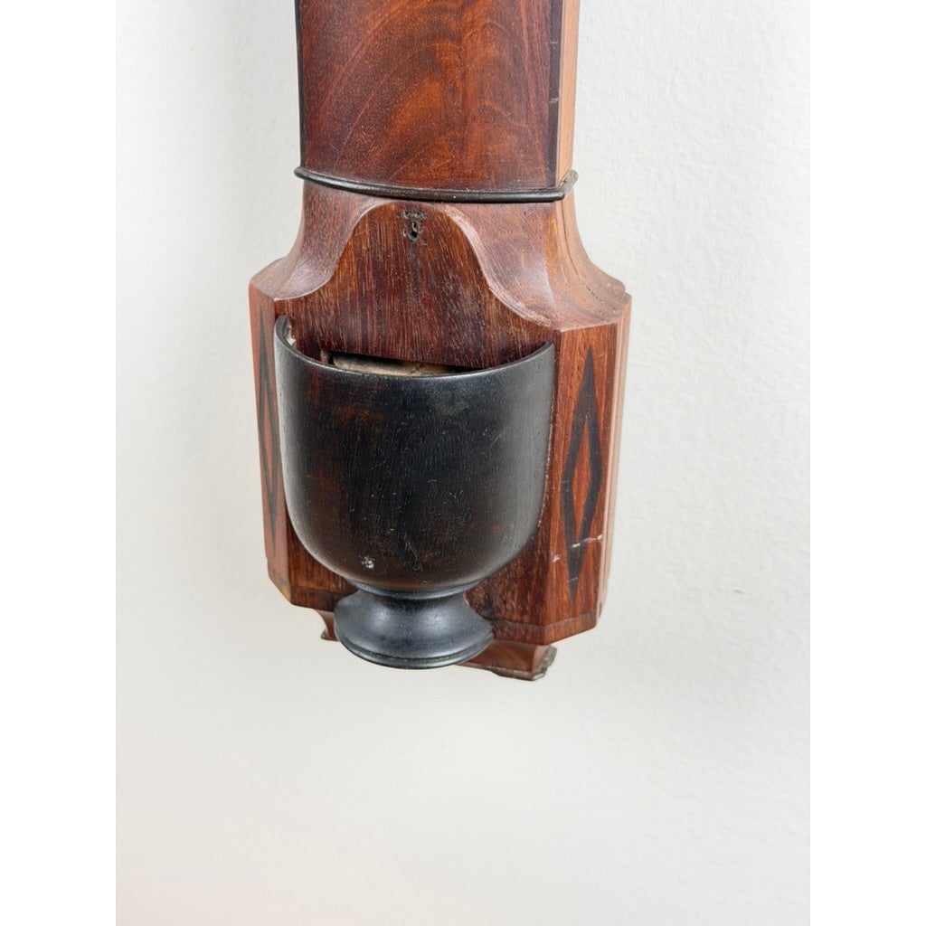 An English Regency Mahogany Stick Barometer by Thomas Jones, Liverpool, c. 1820, featuring a mahogany case with a black urn-shaped reservoir at the base.