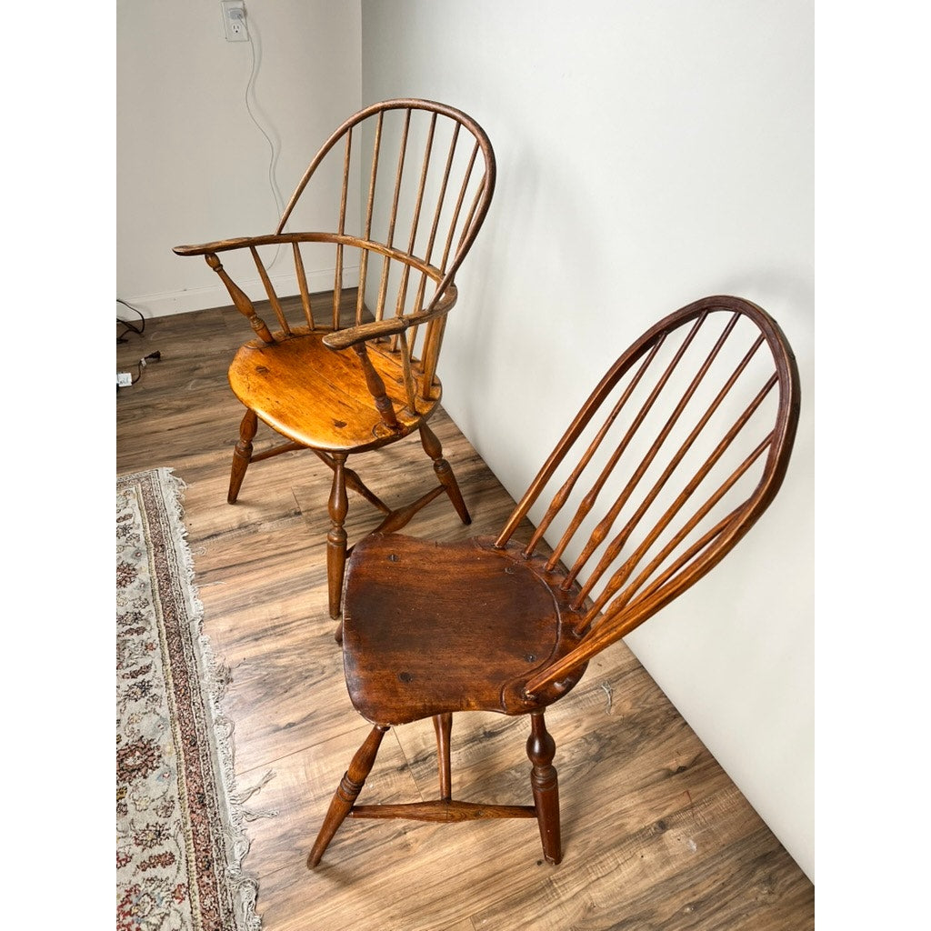 Two Antique Near Pair 18th Century Windsor Chairs, brand unknown, are placed side by side next to a rug.