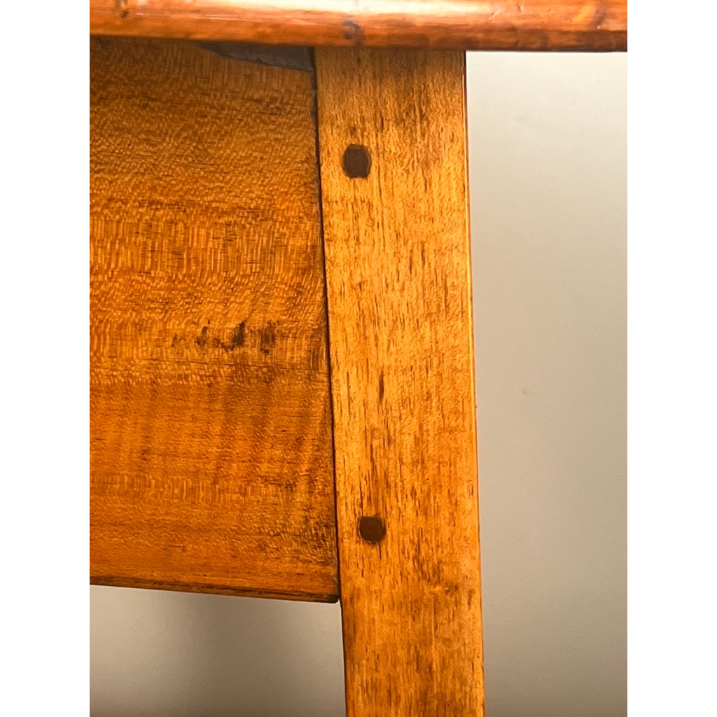 Close-up of a wooden joint on an Antique American Queen Anne Maple Tavern Table, New England, Circa 1760–1790, showing a vertical leg joined to a horizontal surface with two dowel holes and a smooth, warm maple finish.