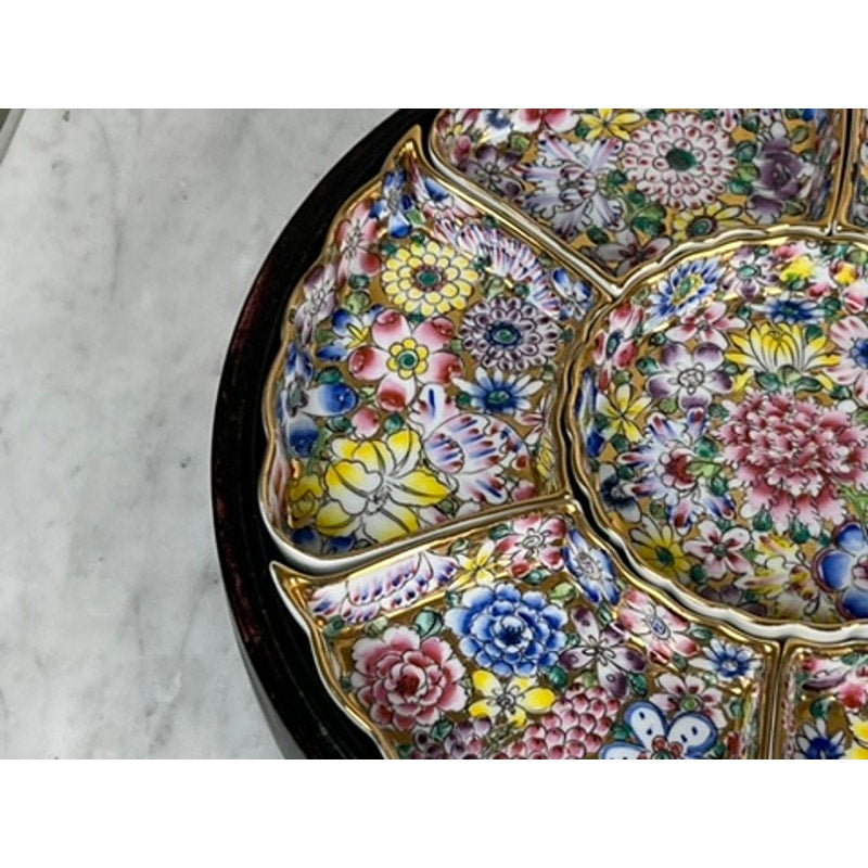 A close-up of a Vintage Chinese Canton Sweet Meat Set with Case (c. Early 20th Century), a segmented famille rose porcelain dish featuring intricate floral patterns outlined in gold, displayed on a marble surface.