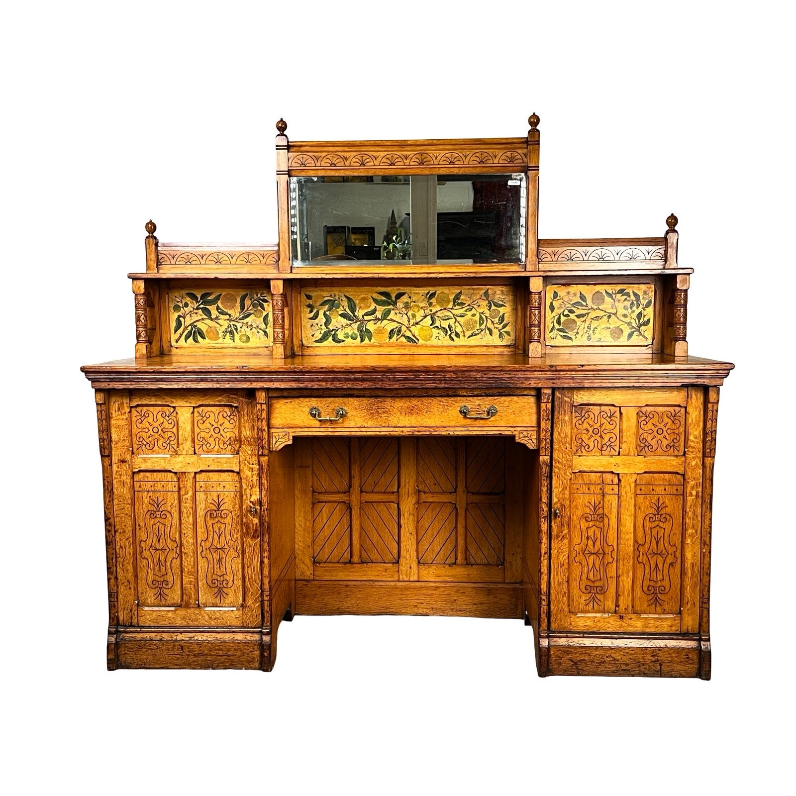 Antique Victorian Aesthetic Movement Oak Desk, late 19th century, with original finish. Features ornate carvings, mirrored back, floral panels, central drawer, lower cabinets, and rich warm oak tones. Brand: Unknown.