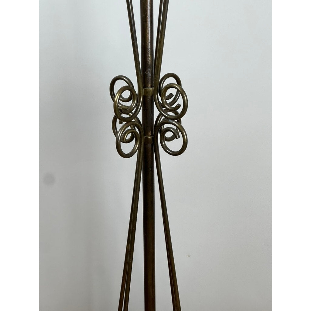 Close-up of an Antique Art Nouveau Brass Floor Lamp attributed to Jules Cayette and Charles Schneider c. 1920, showing four vertical rods joined by ornate, symmetrical coils in a decorative pattern against a white background.