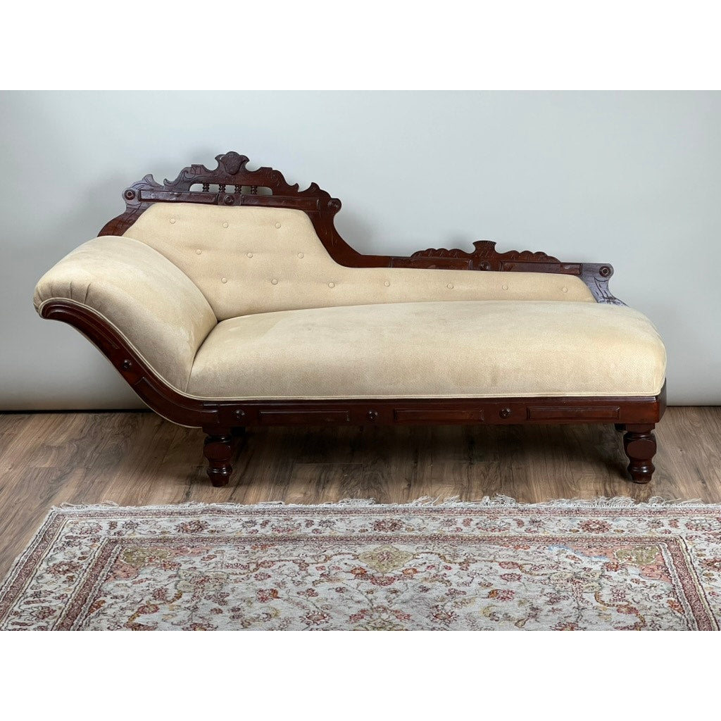 Antique Eastlake Victorian walnut fainting couch with beige upholstery