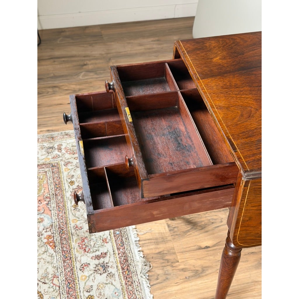 An English Regency Rosewood Two-Drawer Drop-Leaf Work Table with Brass and Satinwood Inlay by Pearl City Antiques, shown in dark wood with two stacked drawers open to reveal internal compartments and small wooden knobs.