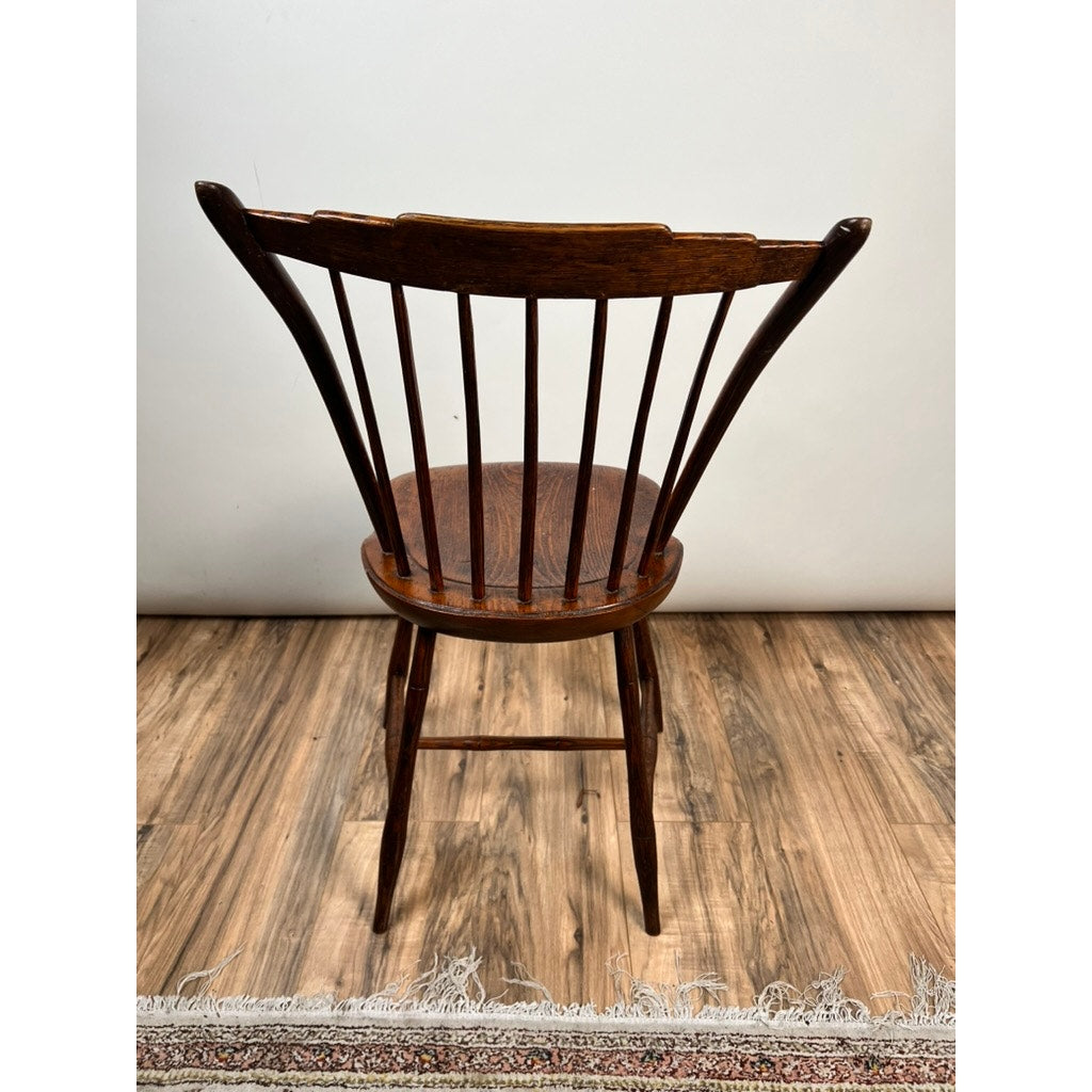 An Antique Step Down Windsor Chair in Oak and Pine (Early 19th Century) sits on a wood floor by a patterned rug, set against a plain white wall. Brand: Unknown.