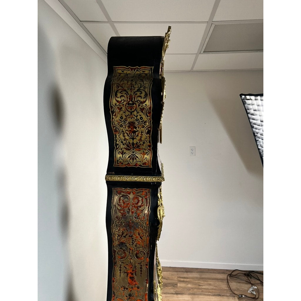 A monumental French Napoleon III Boulle marquetry floor clock with ormolu mounts, circa 1865–1885, featuring intricate gold and red designs, is shown from the side in a modern room with white walls, wood flooring, and a ceiling light panel.