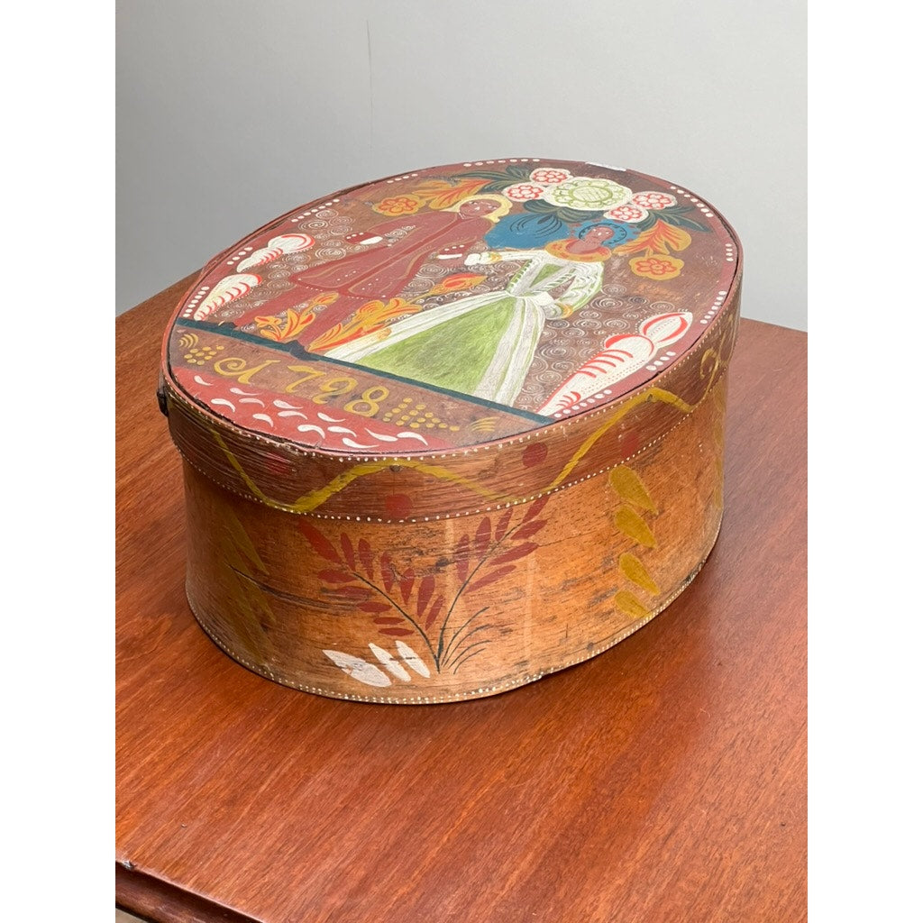 The Antique Swedish Polychrome Painted Marriage Box dated 1798 features colorful hand-painted floral and human motifs on its oval bentwood form, beautifully representing Scandinavian folk art from the late 18th century.