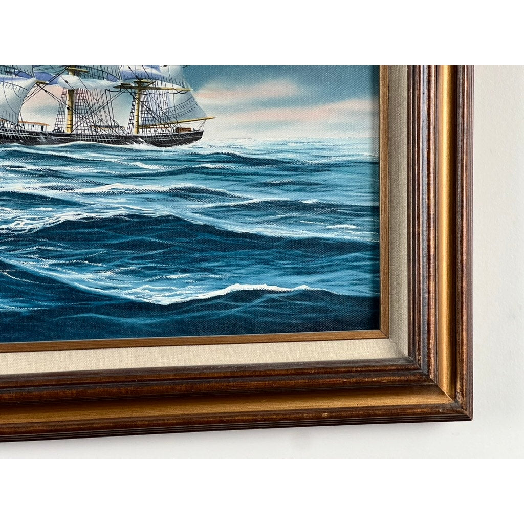 Close-up of “Tall Ship Under Sail” oil on canvas by John Richard Perry (1984), showing a sailing vessel in rough blue waves beneath a cloudy sky, with part of the ornate frame visible on the right and bottom edges.