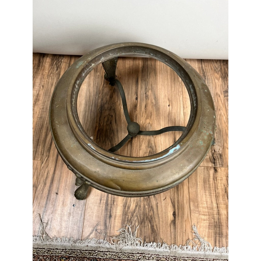 An Antique Venetian Brass Bell Room Heater Brazier (19th Century) with a vintage, tarnished finish sits on three curved legs on a wood floor near a patterned rug. Brand: None/Unknown.