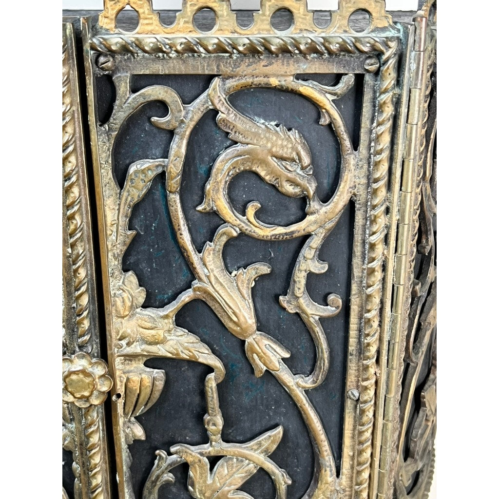 Antique Gothic Revival cast iron and brass phone stand, attributed to Oscar Bach or Bertram Segar c. 1920 Greenwich Village, features ornate swirling floral patterns, a raised dragon design, decorative borders, and detailed artistry on a dark background.