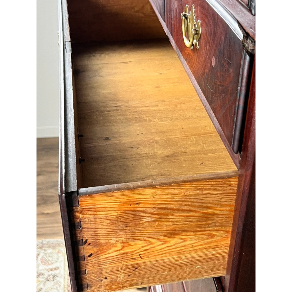 A close-up of an open drawer in an Antique Queen Anne Walnut Chest on Frame with Drake Feet, likely Irish c. late 18th century, shows dovetail joints, brass handles, and striking wood grain that reflect exquisite antique craftsmanship.