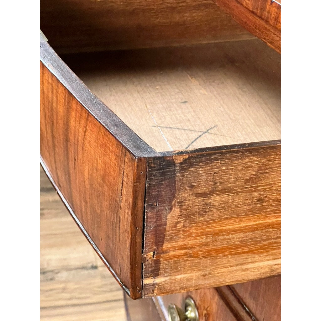 A close-up of a partially open drawer from an Antique George III Mahogany Bowfront Chest on French Feet (late 18th century) shows wear, scratches, a dark stain on the front corner, and a large X mark inside the wood.
