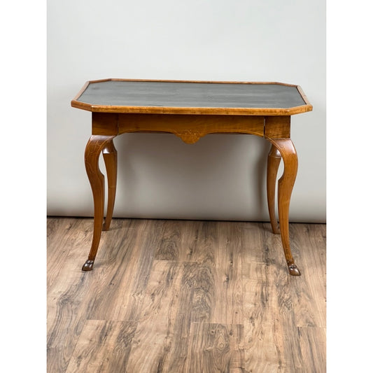 A Pearl City Antiques Antique Louis XV Provincial Walnut One Drawer Writing Desk or Side Table, dating from the 18th century, featuring a dark rectangular top and elegant curved legs, is set against a plain light wall on a wooden floor.