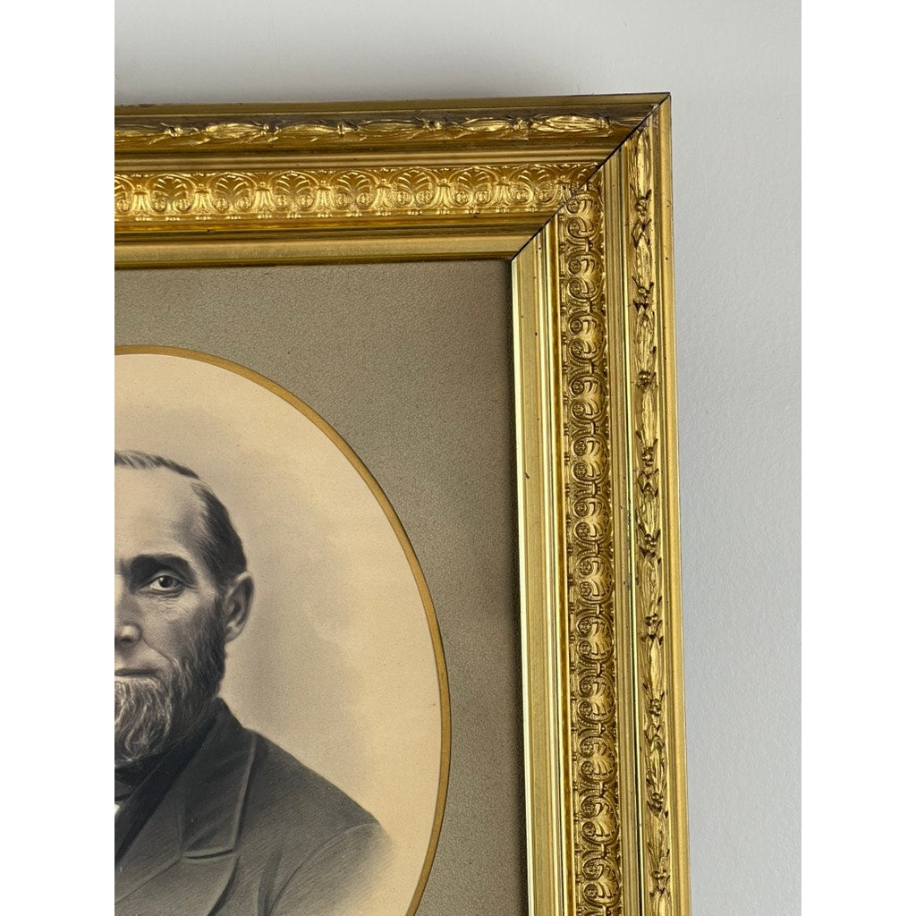 Close-up of the "Antique Civil War Era Portrait of a Gentleman in Gilt Wood Frame," featuring detailed floral patterns and showcasing a sepia-toned image of a bearded man’s left profile and upper body against a neutral background.