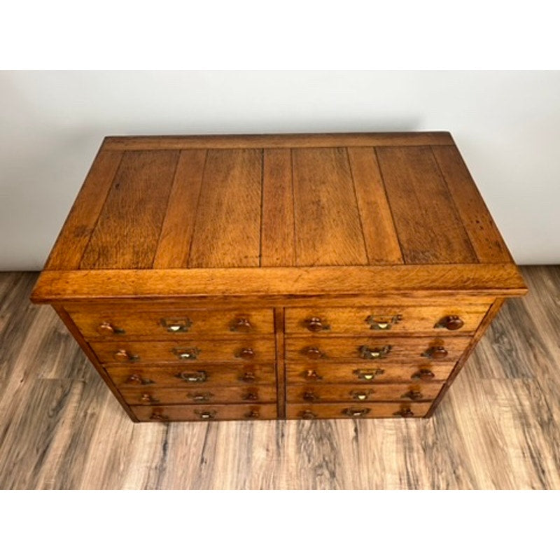 Early 20th century oak file cabinet with multiple drawers, antique office furniture.
