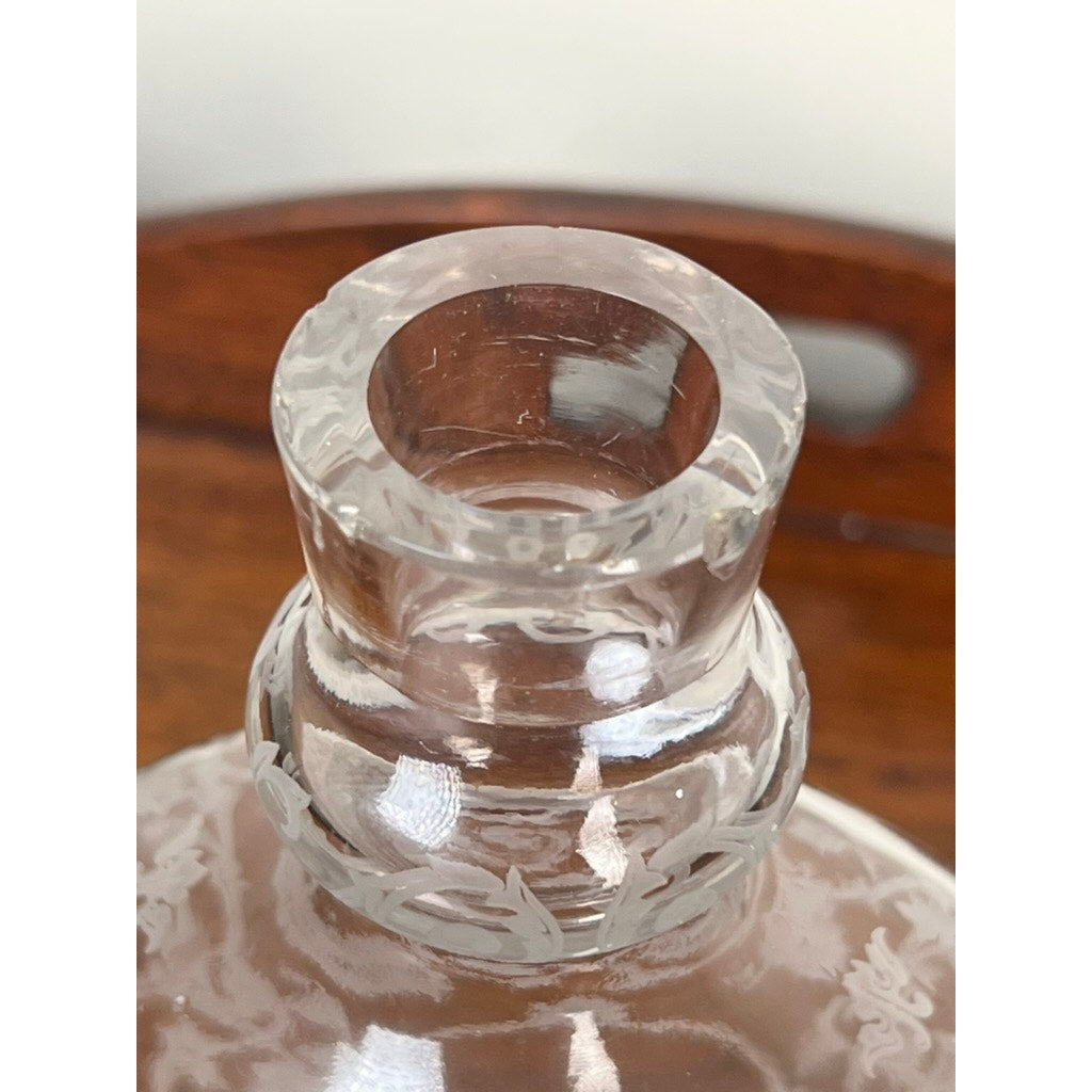 Close-up of the neck and rim of a Baccarat "Michelangelo" vintage crystal decanter for Martell Cognac (c. 1930), with decorative etching, displayed on a wooden surface.