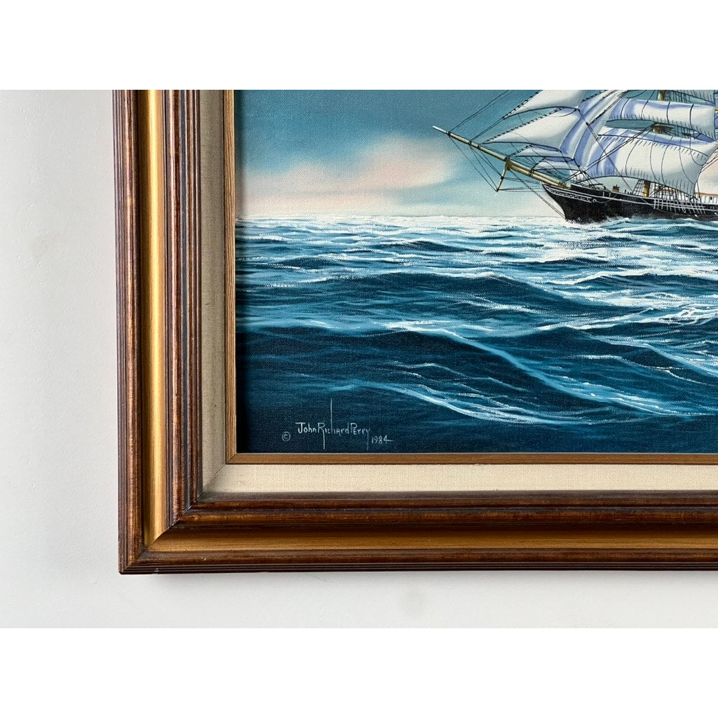 A close-up of “Tall Ship Under Sail” Oil on Canvas by John Richard Perry ME 1984 shows waves and part of a sailing vessel, with the artist’s signature visible in the lower left corner.