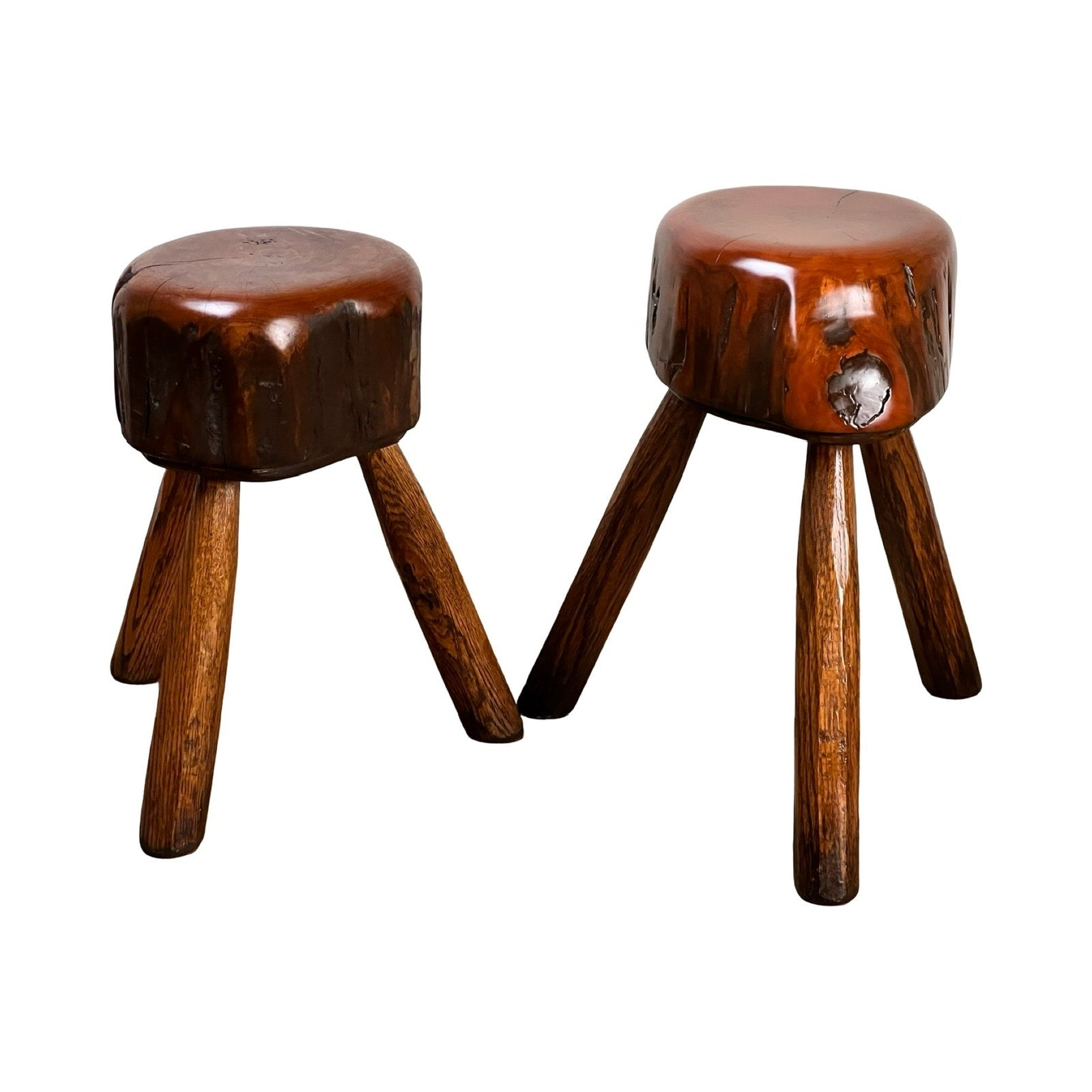 Pair of vintage live edge cherry stools signed by Neil Panyik, each with three outward-angled legs, solid wood seats showing natural knots, and handcrafted for a subtle Wabi Sabi aesthetic. Brand: unknown.