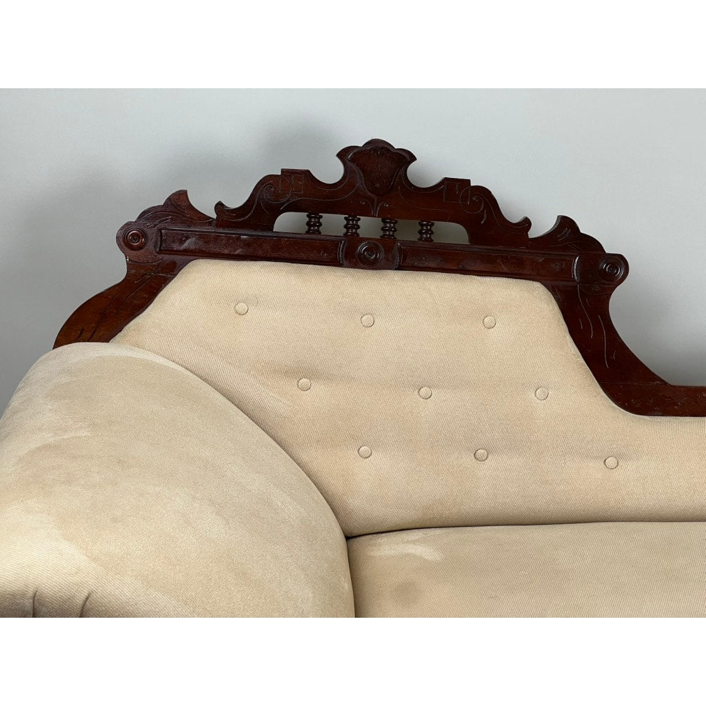 Antique walnut fainting couch with tufted beige upholstery Eastlake style