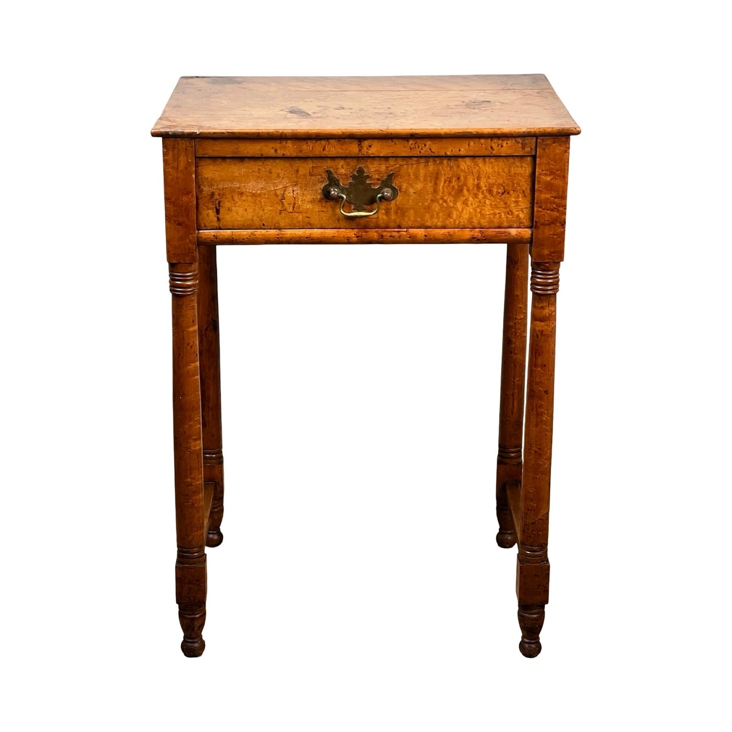 An early 19th-century Antique Sheraton birdseye maple one-drawer stand with a brass handle, four turned legs, and a natural wood finish; style evokes American Federal period furniture. Brand: Unknown.