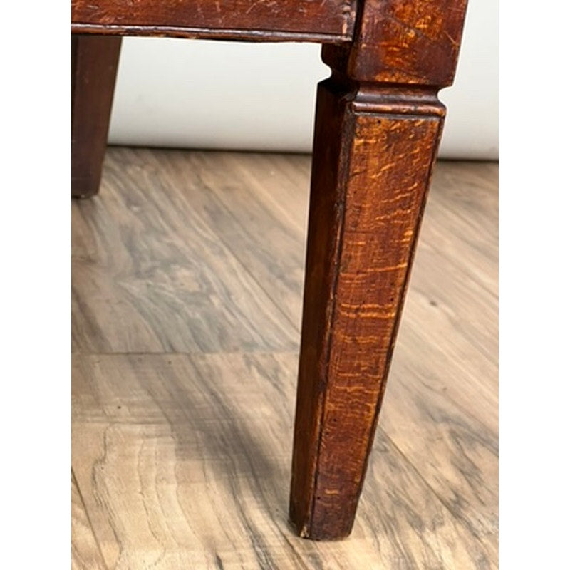 Close-up of a wooden chair leg on a wooden floor