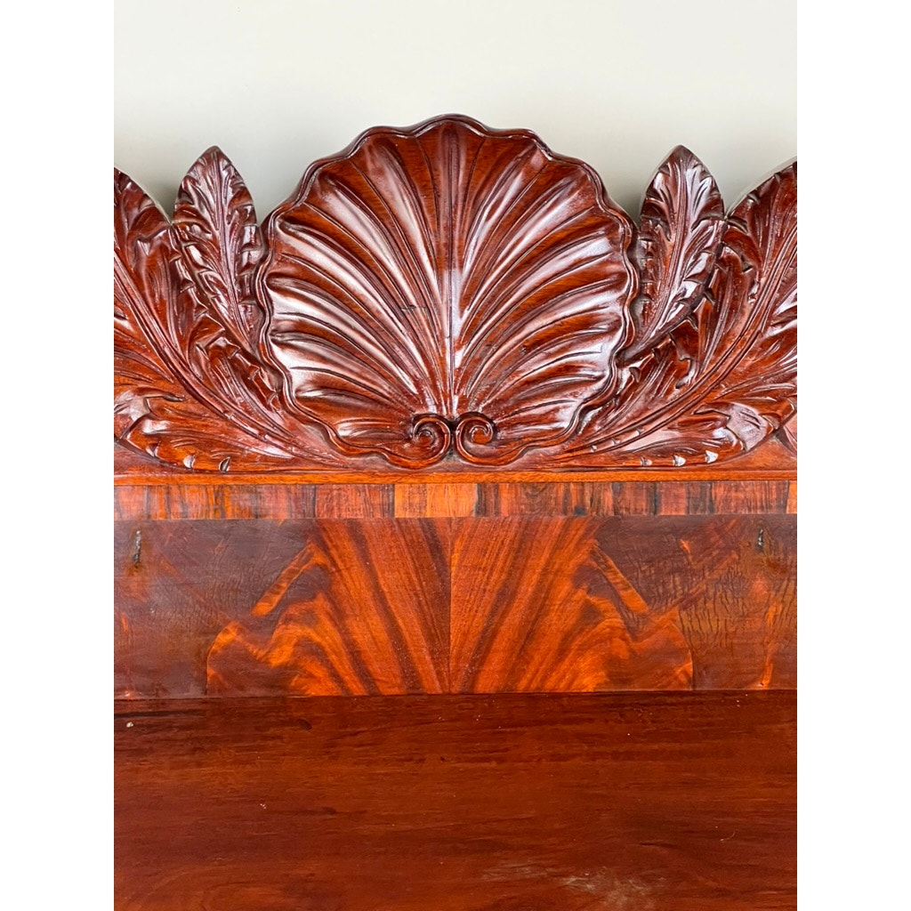 A close-up of the Antique American Empire Mahogany Sideboard, probably from Philadelphia c. 1840, shows its polished flame mahogany and rosewood edge banding with intricate carved motifs. Brand: Unknown.