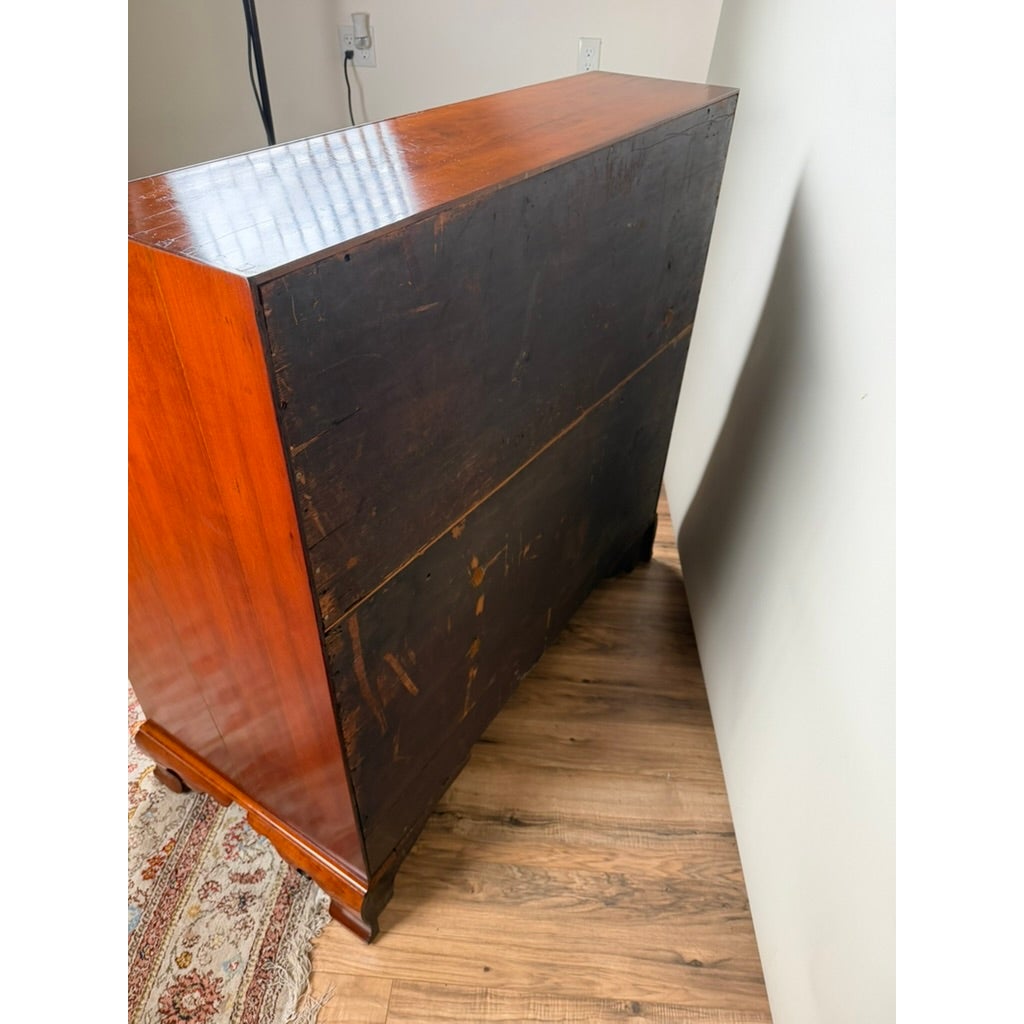 A rear view of a Chippendale Cherry Slant-Front Desk with Ogee Bracket Feet, Possibly Connecticut River Valley, circa 1770–1790, featuring a dark, paneled back and ogee bracket feet.