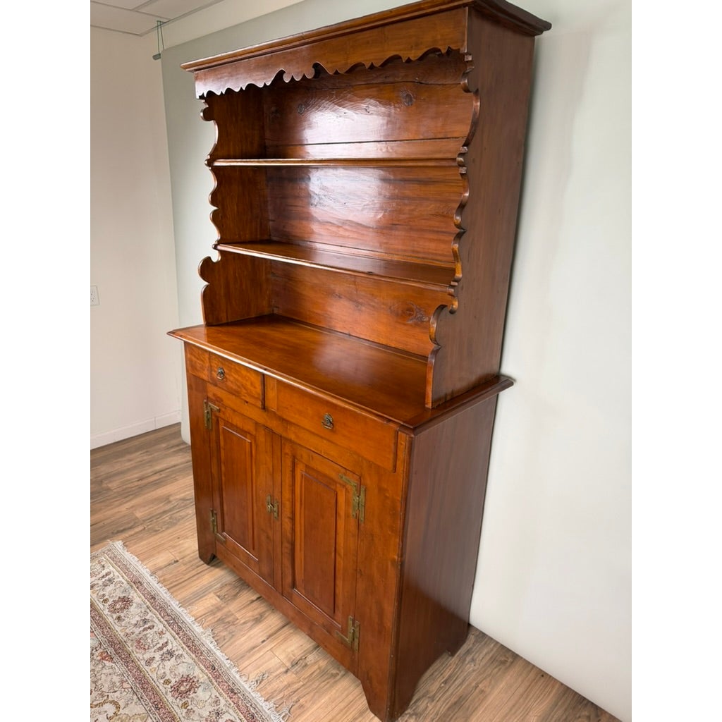 Pennsylvania or Mid-Atlantic Cherry Open Pewter Cupboard, circa 1800–1830, featuring an open three-tiered shelf top over a base with two drawers and two cabinet doors.