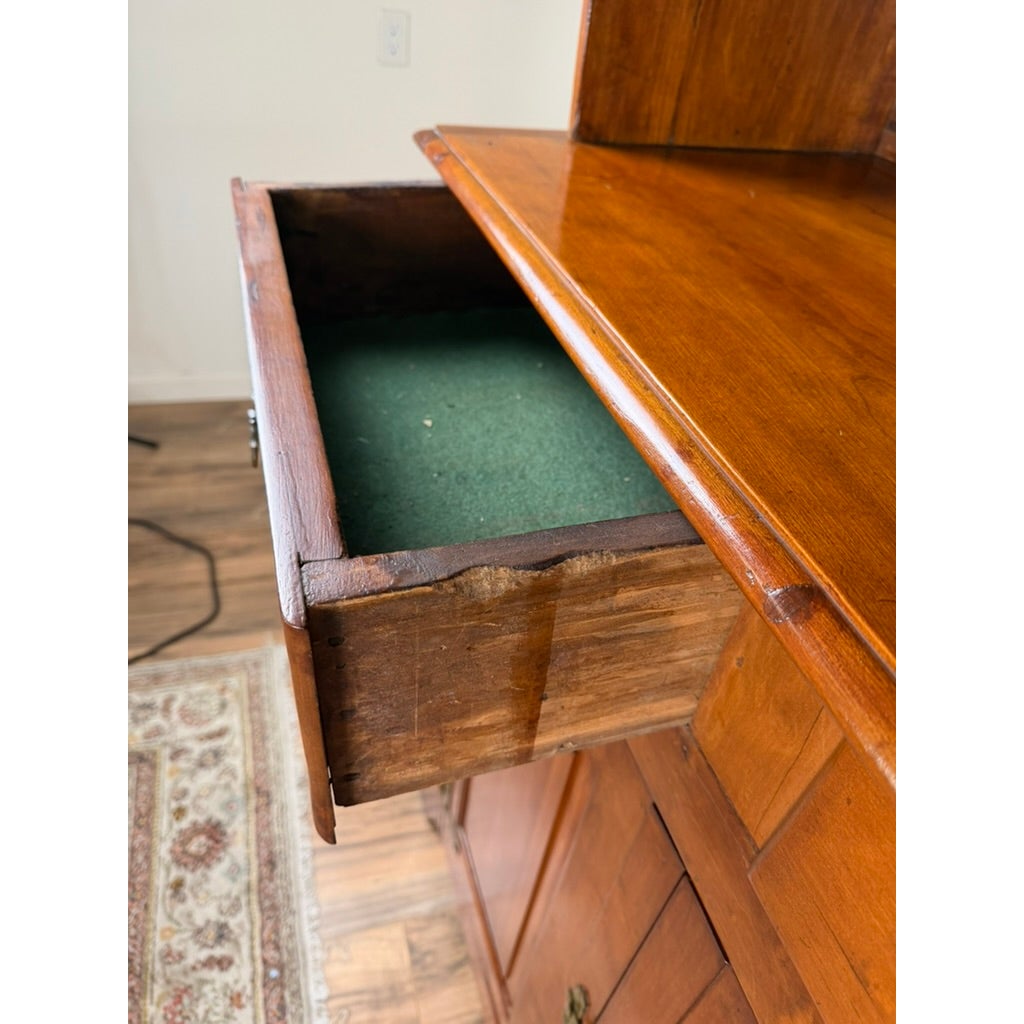 A Pennsylvania or Mid-Atlantic Cherry Open Pewter Cupboard from Pearl City Antiques featuring an open drawer lined with green felt.