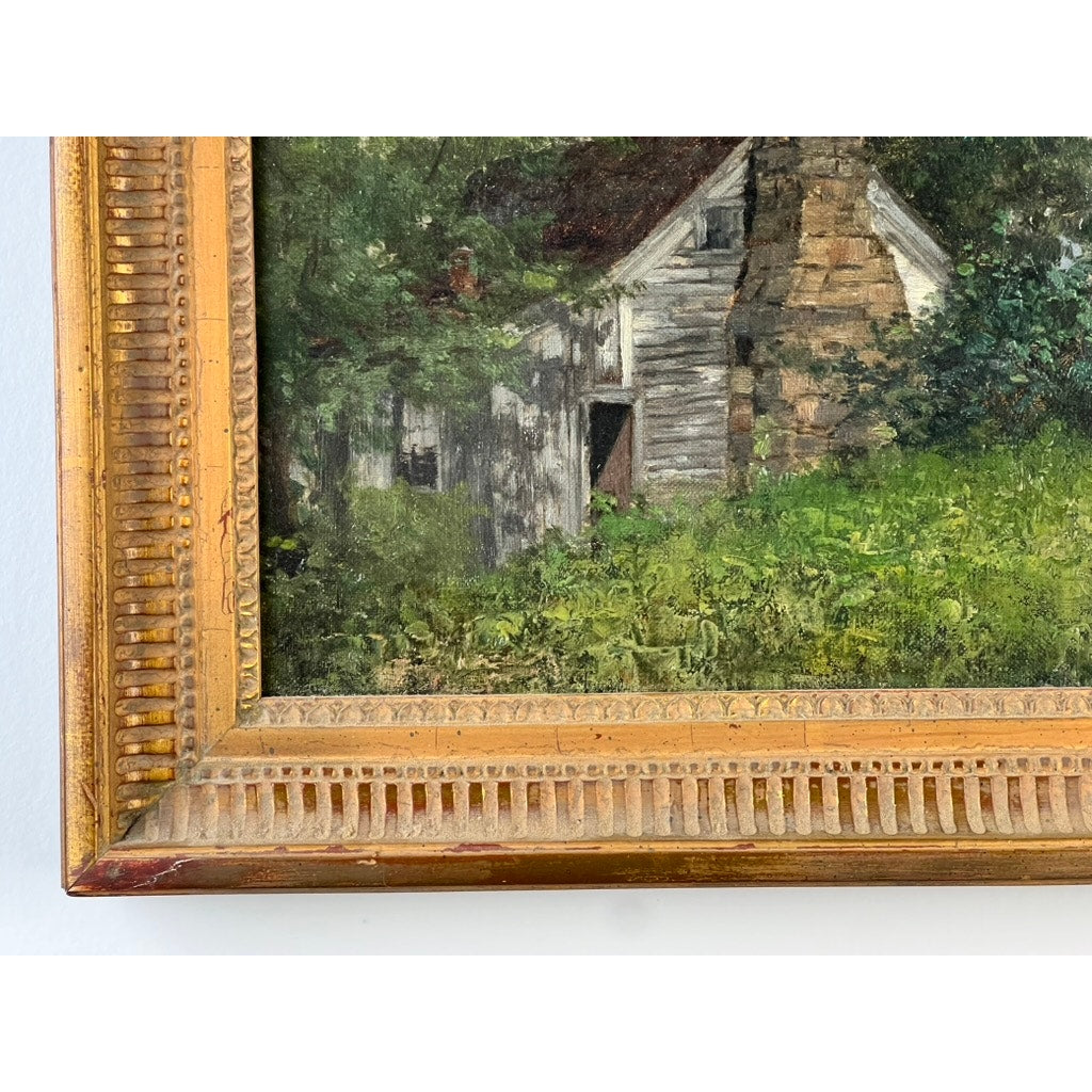 Close-up of the bottom left corner of an Antique American School Farmstead Landscape Oil Painting, Circa 1900, depicting a rustic wooden building amid greenery in a detailed gold-colored frame; artist unknown.