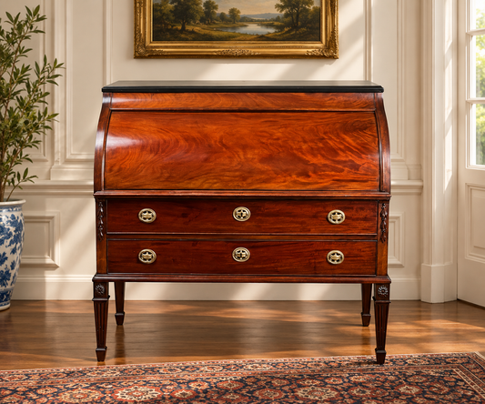 Antique Directoire Style French Cylinder Desk with Slate Top c. Late 19th Century, a mahogany cylinder desk featuring a dark stone top and two drawers with brass ring pulls.