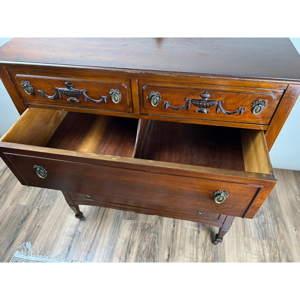 The Antique Depression Era Mahogany Two Over Three Chest of Drawers (c. 1930s) features ornate metal handles, two upper drawers, three lower drawers (one partially open), and stands elegantly on a wooden floor. Brand: Unknown.