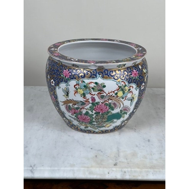 A statement planter, the Vintage Chinese Famille Rose Fish Bowl Signed Minicucci features hand-painted porcelain with colorful floral and bird designs, pink peonies, and blue, green, and gold accents.