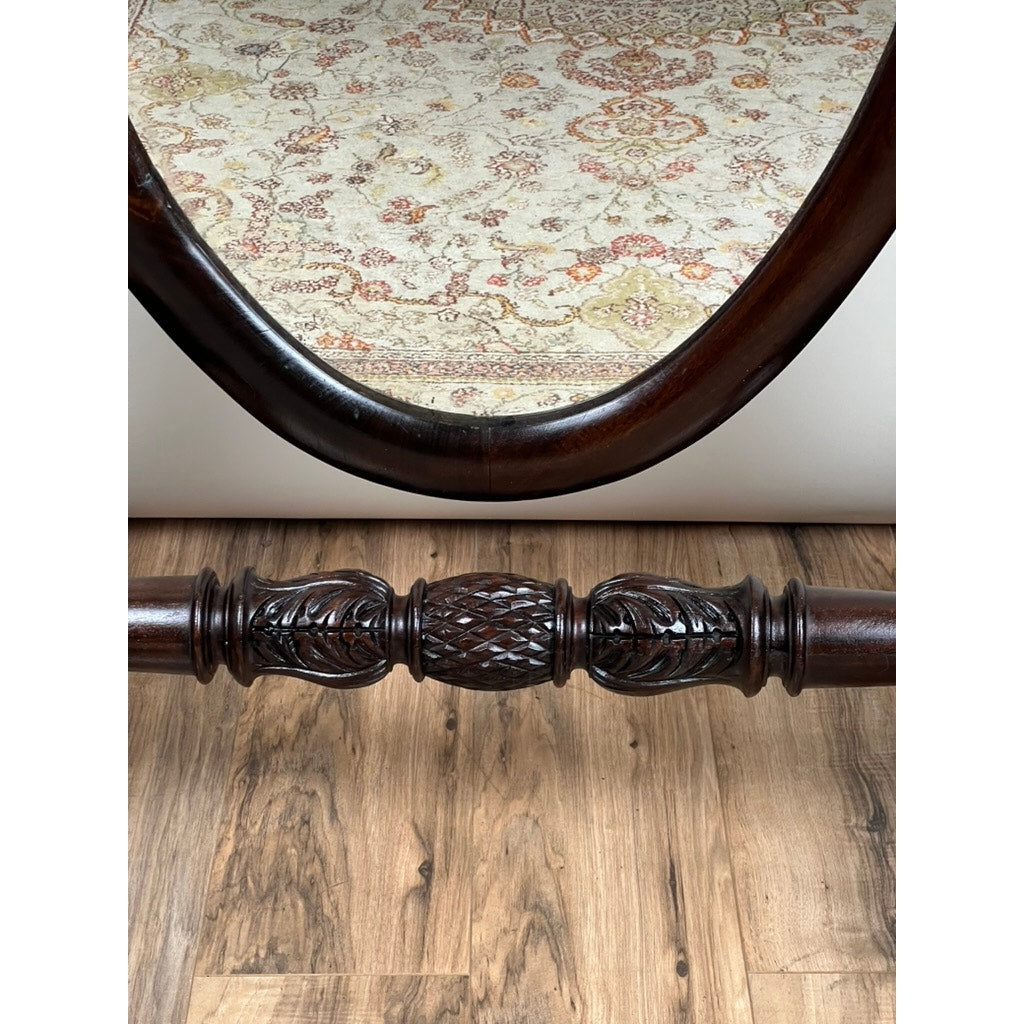 A close-up of the Impressive Antique American Empire Acanthus and Barbola Rose Carved Cheval Mirror c. 1840 shows its ornate dark wood frame reflecting part of a light-patterned rug, resting on a wooden floor. Brand: Unknown.