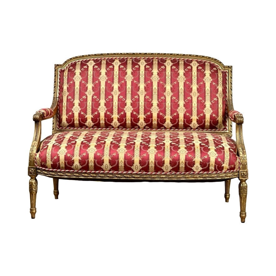 Antique Louis XVI style giltwood settee in silk damask, late 19th century, featuring a carved wooden frame with gold accents and red upholstery with gold floral and stripe patterns, shown against a white background. Brand: Unknown.
