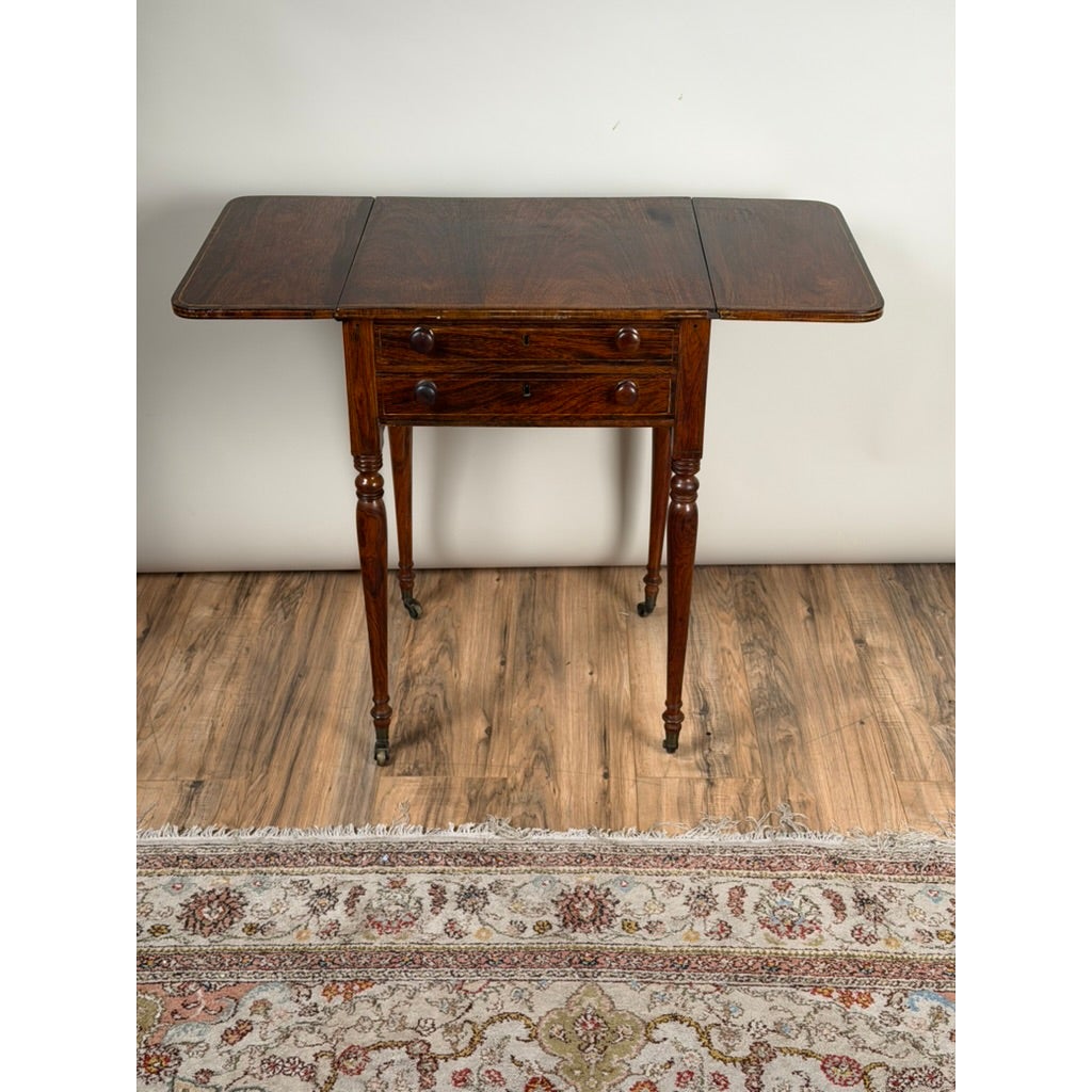 English Regency Rosewood Two-Drawer Drop-Leaf Work Table with Brass and Satinwood Inlay, featuring turned legs and casters.