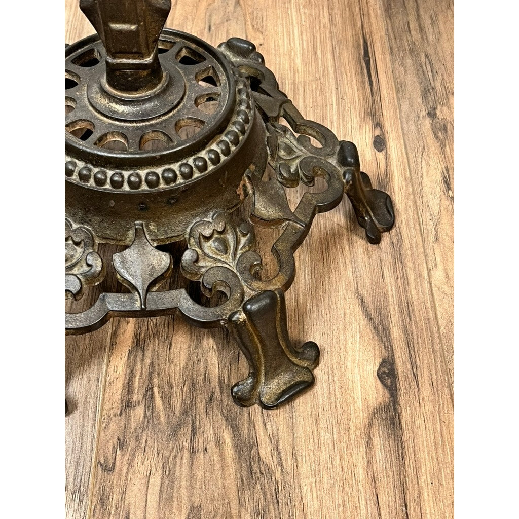 The Antique Art Deco Cast Iron Floor Lamp by Rembrandt features a bronzed, ornate metal base with decorative legs and intricate cut-out designs, adding timeless elegance to your space.