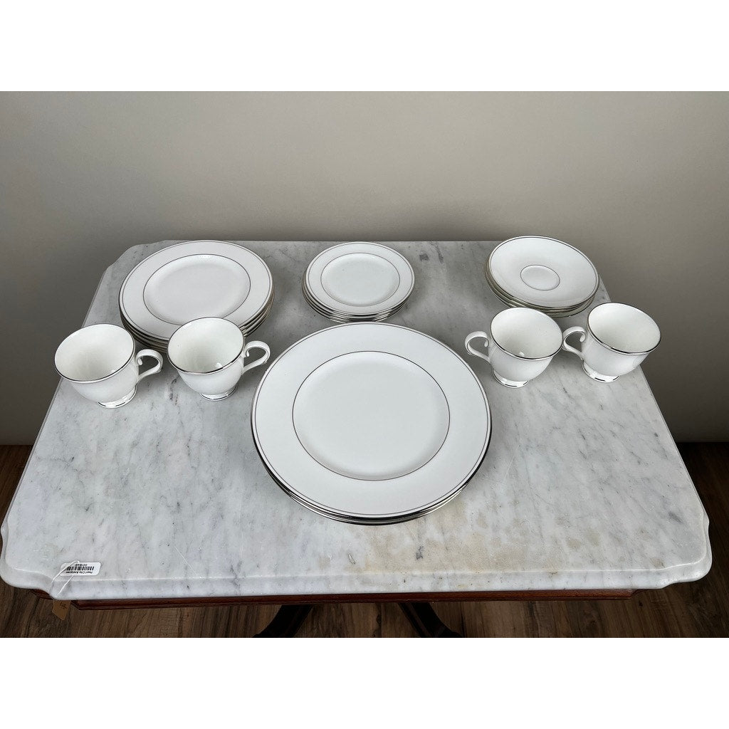 A Vintage Lenox Federal Platinum Fine English Bone China Service for Four is displayed on a marble table, featuring plates, cups, and saucers from Lenox, all accented with silver trim and elegantly grouped in pairs.