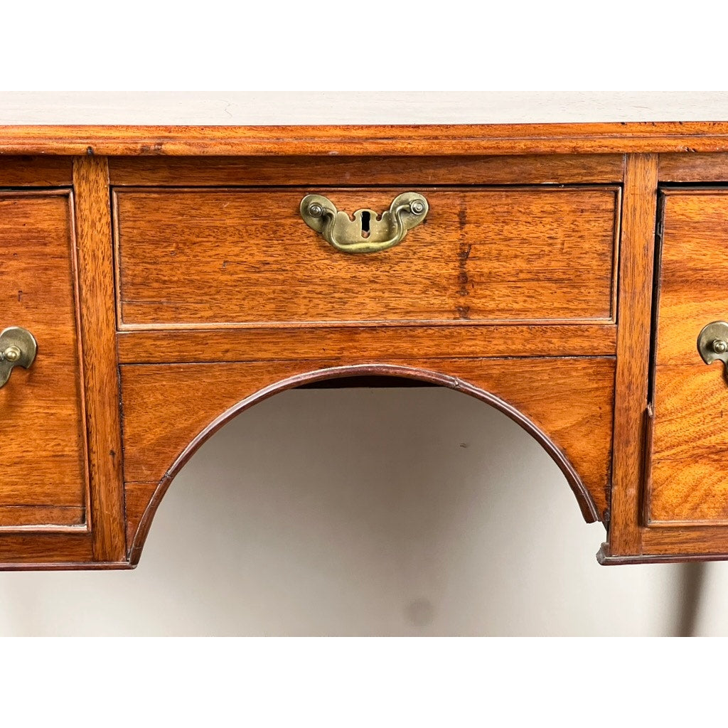 Close-up of an Antique George III Queen Anne Mahogany Lowboy c. Late 18th Century, featuring a brass handle, central keyhole, warm polished finish, and arched cutout base in the classic Queen Anne style. Brand: Unknown.